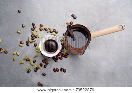 Turkish Coffee with coffee beans and Cardamom scattered on a vintage background
