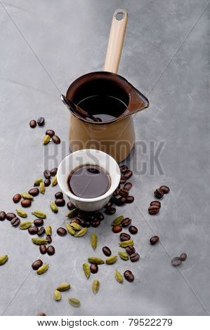 Turkish Coffee with coffee beans and Cardamom scattered on a vintage background