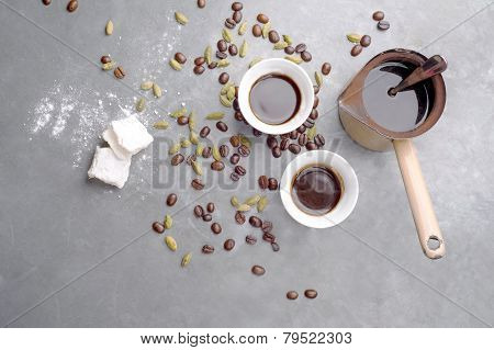 Turkish Coffee with coffee beans and Cardamom scattered on a vintage background