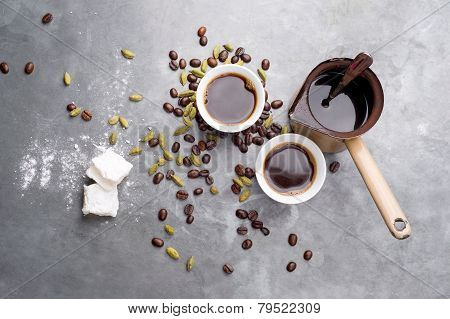 Turkish Coffee with coffee beans and Cardamom scattered on a vintage background