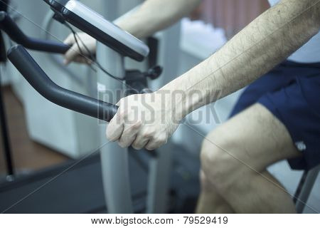 Young Man On Exercise Bike