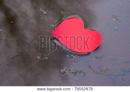 Paper shaped heart in water stream