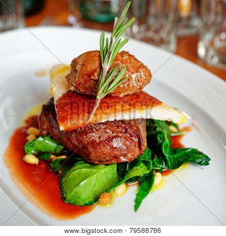 Tenderloin steak with beef terrine and spinach in plate