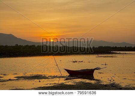 silhouette fishing boat and sunset
