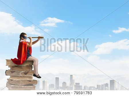 Cute girl of school age wearing super hero costume