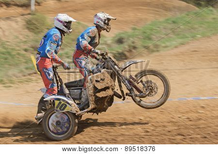 Dynamic Shot Of Two Racers Standing On The Sidecar