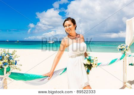 Wedding Ceremony On A Tropical Beach In Blue. Happy Bride Under The Wedding Arch