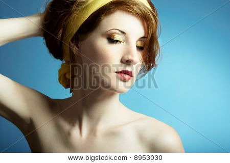 Portrait of the young woman on blue background