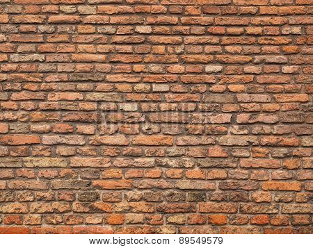 Medieval rough brick wall of small bricks