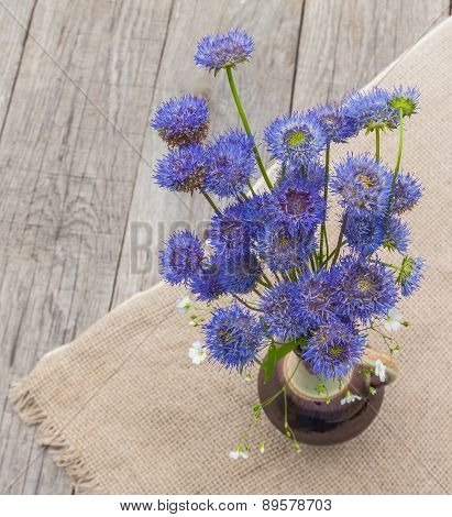 Rustic Still Life With A Bouquet Of Blue Flowers On A Wooden Background