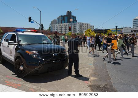 Police Watching Protestants In The Streets With Signs