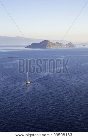 Aerial View Of A Lonely Sailboat Sailing Through The Calm Aegean Sea
