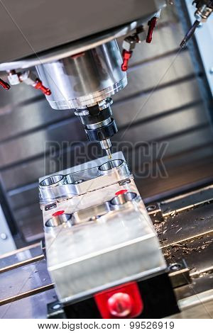Metalworking CNC milling machine. Cutting metal modern processing technology. Small depth of field. Warning - authentic shooting in challenging conditions. A little bit grain and maybe blurred.