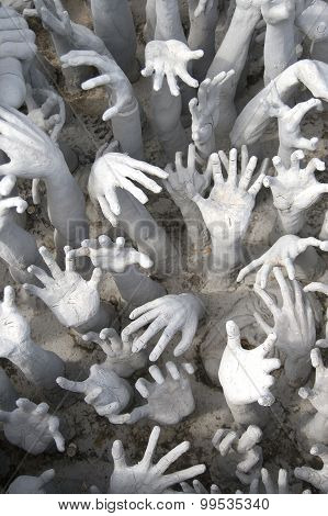 Many hands reaching up to grab.