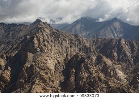 Aerial view of desert and high mountain from the airplane window. New Delhi-Leh flight ,India.