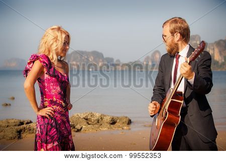 Blonde And Guitarist Side-view On Beach