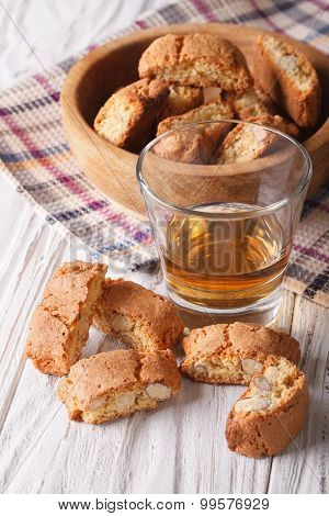 Almond Biscotti Biscuits And Sweet Wine In A Glass. Vertical