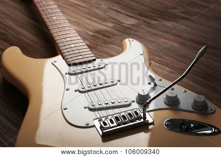 Electric guitar on wooden background, close up