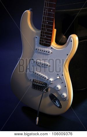 Electric guitar with musical equipment on dark background