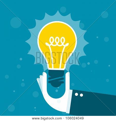Innovation - hand holds shining light bulb