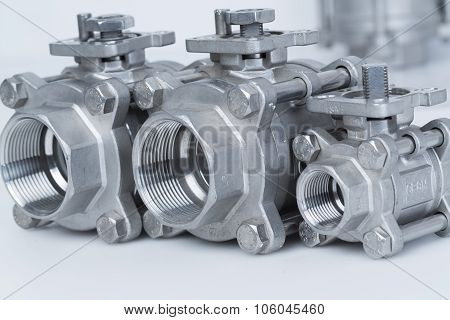 Group 3 valves different sizes ball valve with selective focus on thread fittings