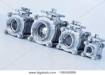 Group 4 valves located on the diagonal different sizes ball valve with selective focus on thread fittings