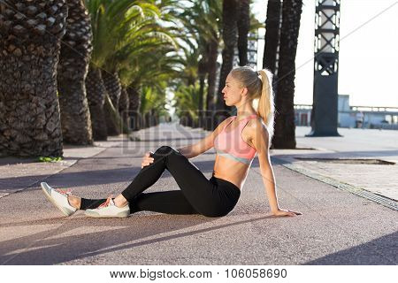 sportswoman  doing fitness exercise outside in palm park