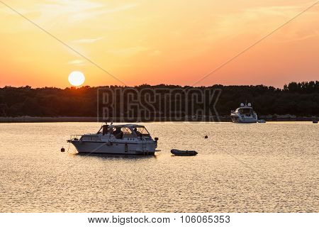 Awesome colored sunset and yacht on the sea