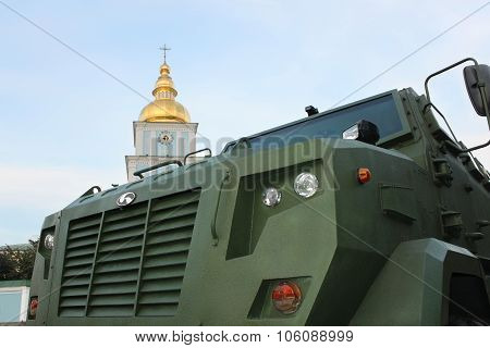 Military Vehicle Close-up Against The Church Bell Tower