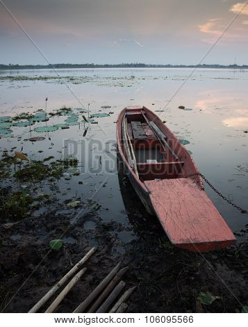 Moored Fishing Boats On Lake In Asia With Sunset Background