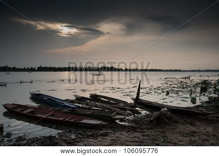 Moored Fishing Boats On Lake In Asia With Sunset Background