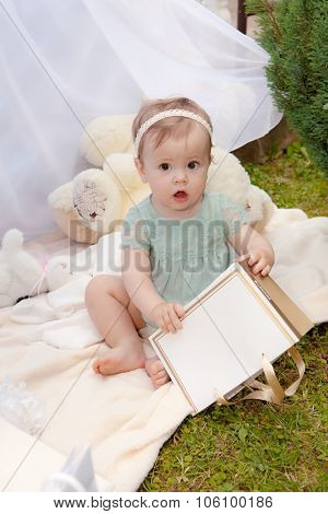 Baby playing in a park near the tents of baldachin