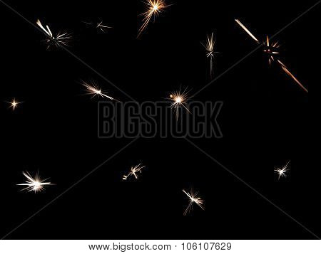 Stars, sparks from sparklers on a black background
