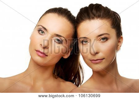 Two attractive sisters with make up.