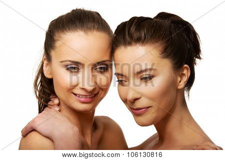 Two attractive sisters with make up embracing.