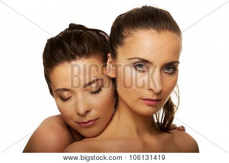 Two attractive sisters with make up.