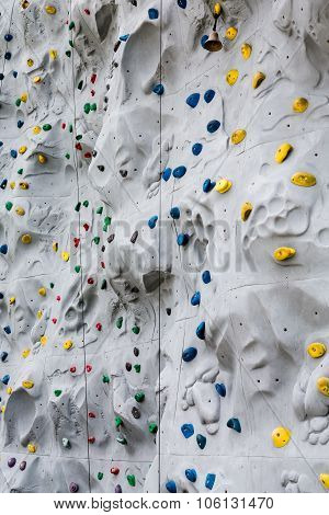 Colorful Hand And Foot Holds On Climbing Wall