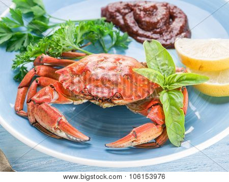 Seafood dish - cooked crab with lemon and herbs.