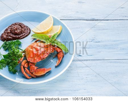 Seafood dish - cooked crab with lemon and herbs.