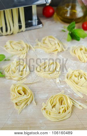 Fresh Homemade Pasta Machine Pasta, Basil, Tomatoes On A Wooden Background