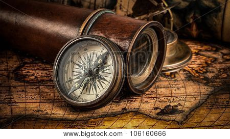 Travel geography navigation concept background - panorama of old vintage retro compass with sundial, spyglass and rope on ancient world map