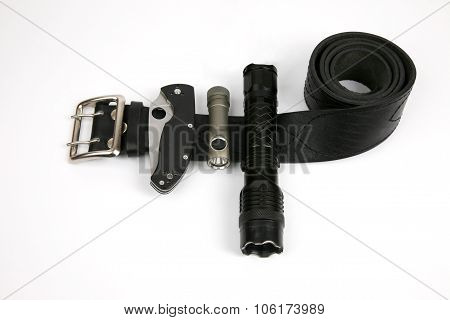 Folding Knife, A Flashlight And A Taser On A Black Leather Strap