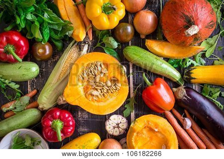 Fresh Vegetables Scaterred On A Rustic Dark Textured Table. Autumn Background