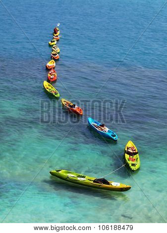 Line of colorful kayaks
