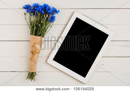 Bouquet Of Wildflowers With Tablet Computer