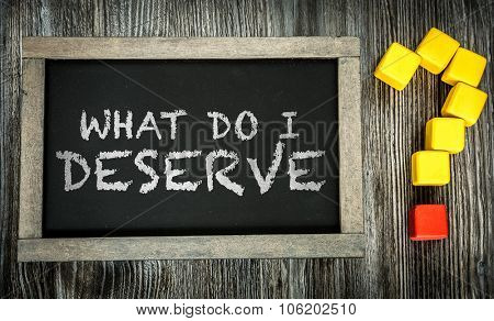 What Do I Deserve? written on chalkboard