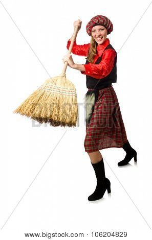 Funny woman in scottish clothing with broom