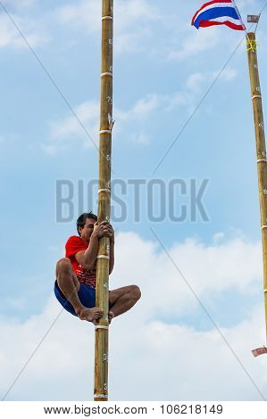 Climbing up the oiled pillar