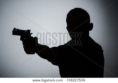 Shadow of the man with gun