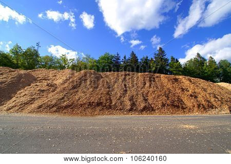 Storage Of Wooden Bio Fuel Against Blue Sky